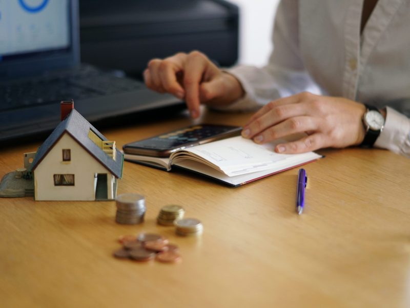 A closeup shot of a person thinking of buying or selling a house